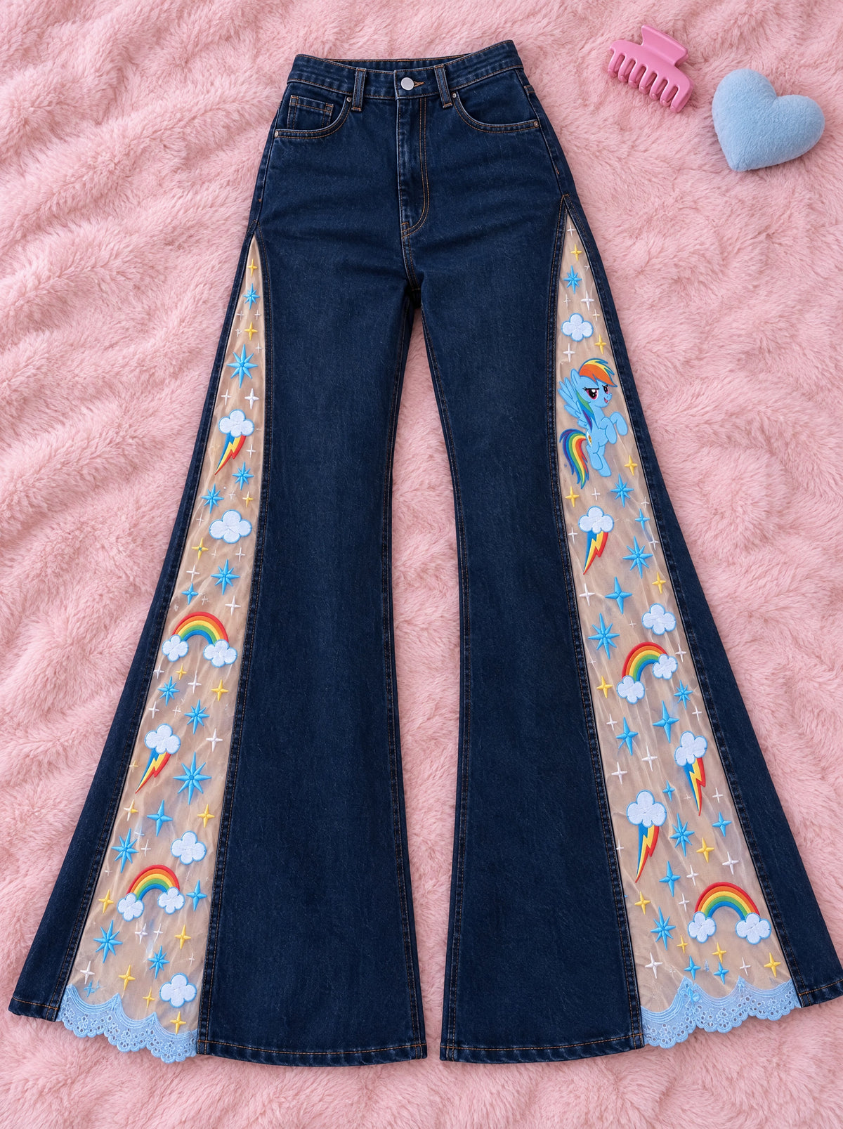 Rainbow Clouds flare jeans laid flat on a pink blanket